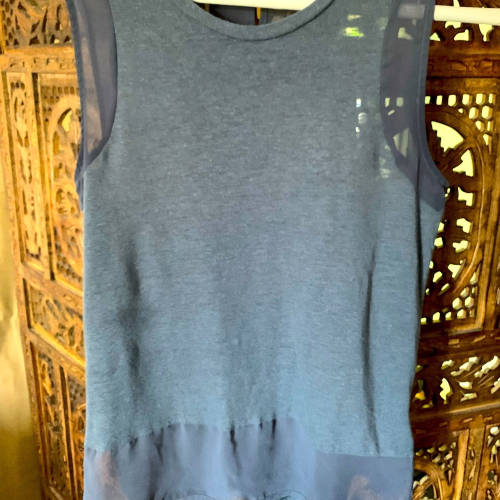 Cute top and be worn dressed up or down. Has some sheer edges and back 1/2 sheer